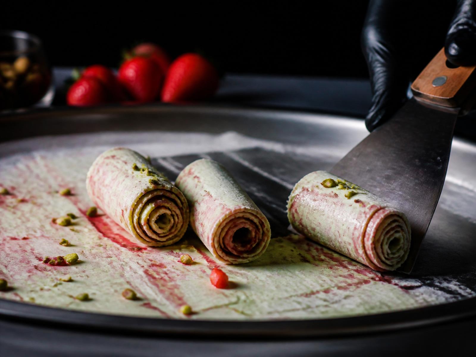 Rolled ice cream being made on a cold plate